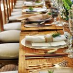 Close-up of a beautifully arranged table setting with flowers and cutlery, perfect for weddings or fine dining.